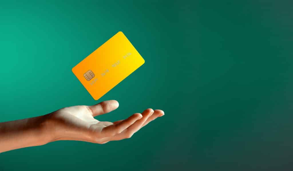 yellow credit card on green background