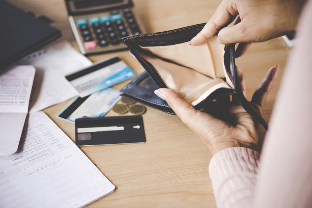 A woman's hand holding an empty wallet