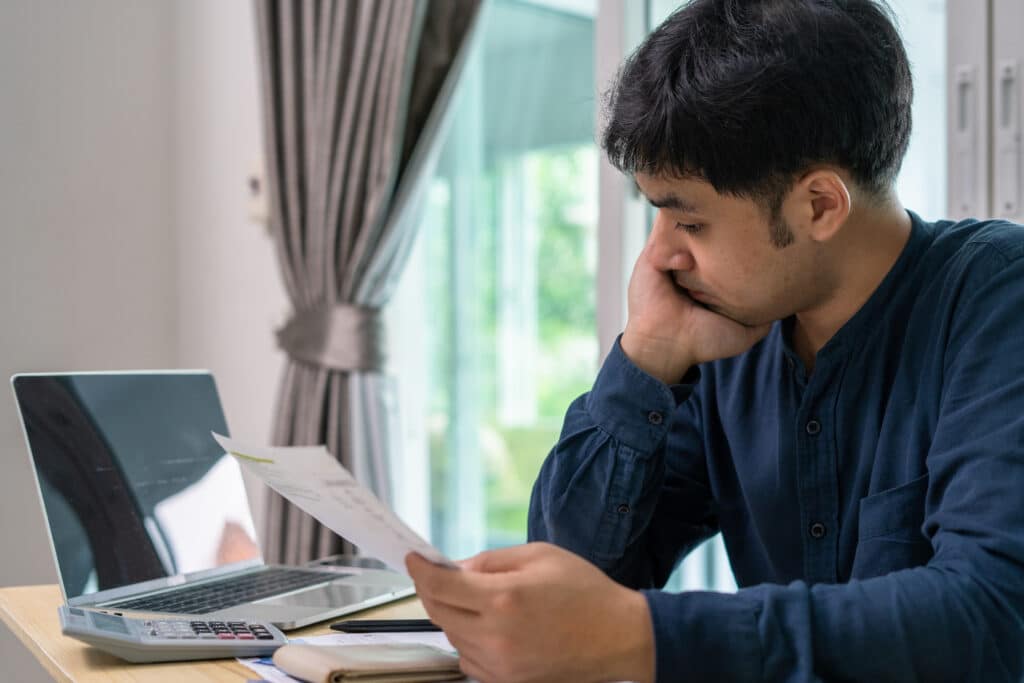 Man looking at financial papers