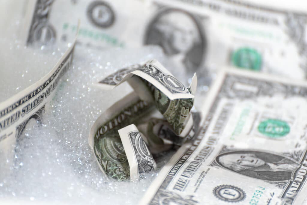 Debt Snowball. debt repayment. dollar bills in snow.