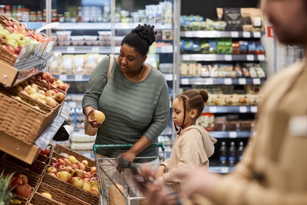 woman and daughter shopping on a grocery budget.