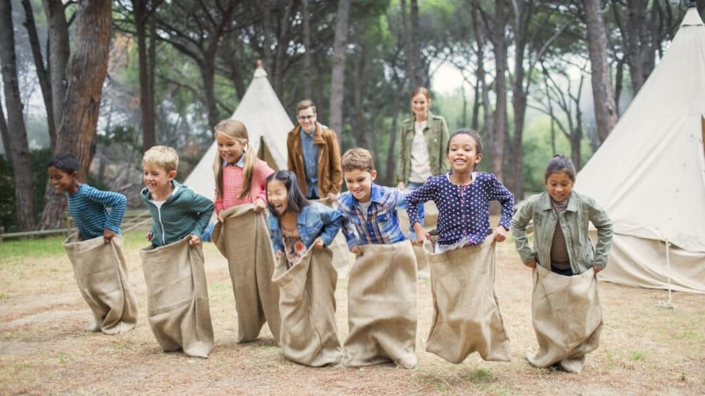 summer camp, kids in a sack race