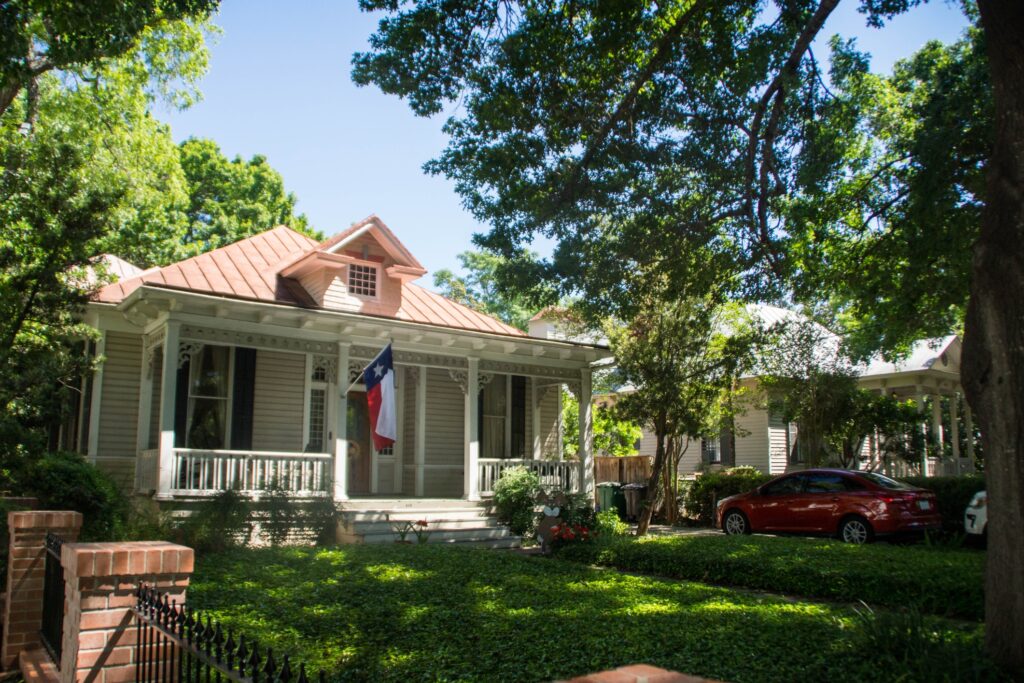 bad credit can cost you more on mortgages—like this lovely white house with trees and lawn.