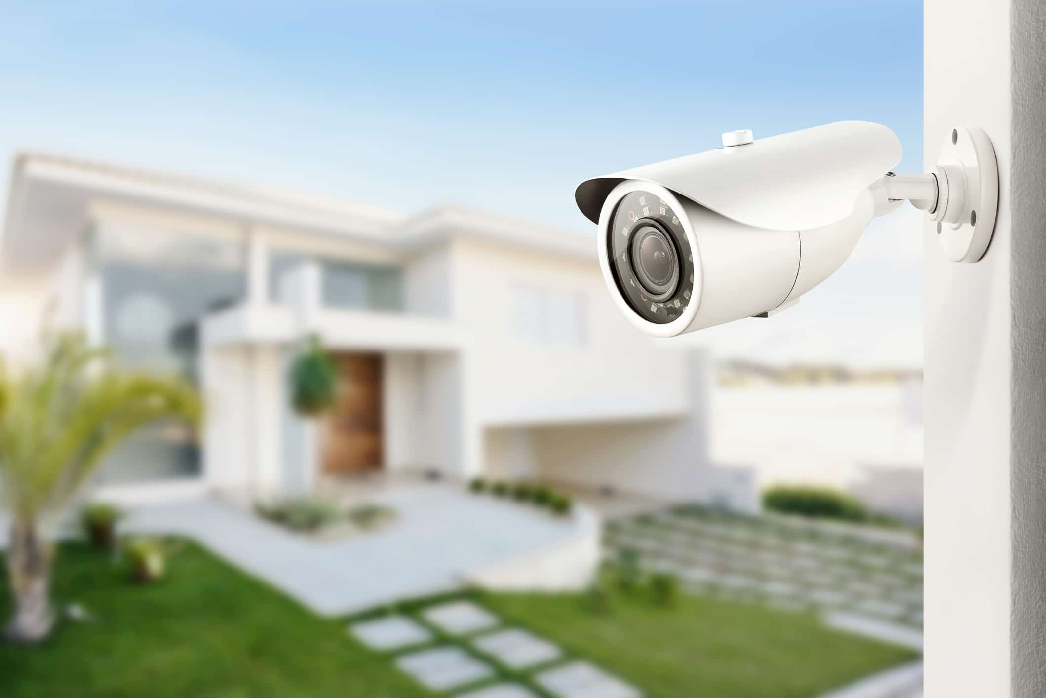 home safety measures—security camera mounted on wall outside house.