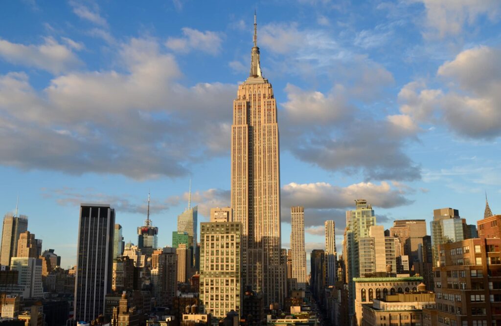 trip on a budget to new york city, nyc skyline with clouds.