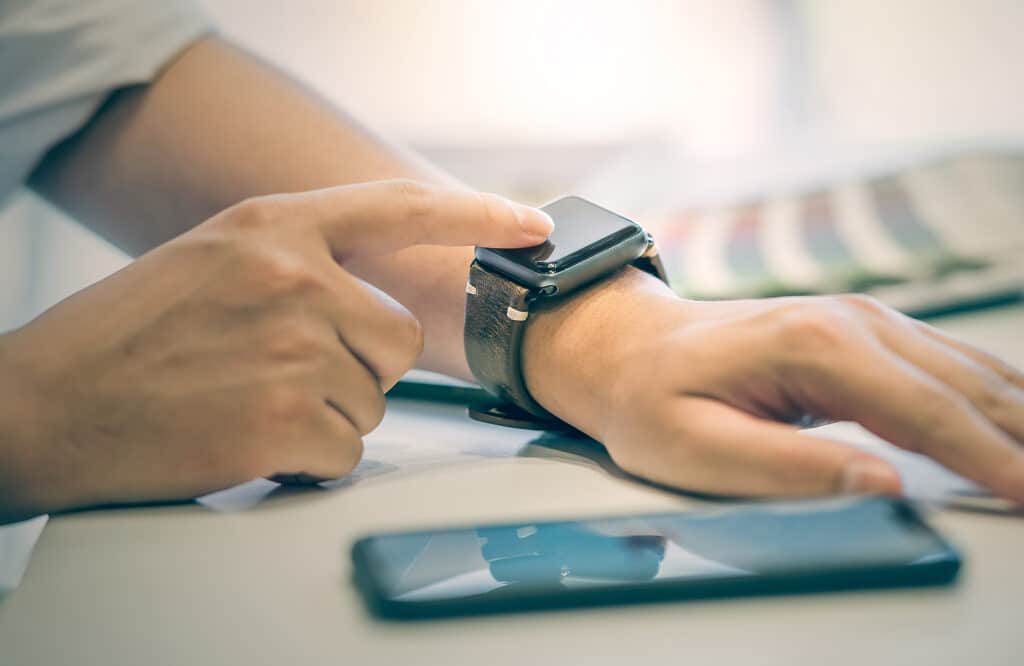 manage money. Businessman using smartwatch while working at office, man touching on smartwatch screen.New technology concept