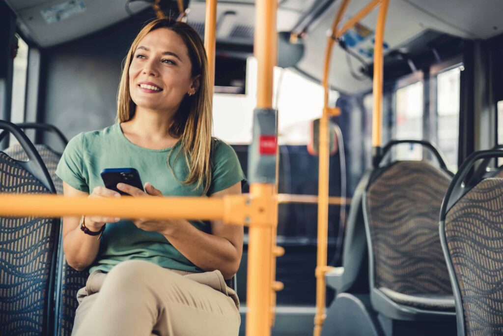 transportation costs. Woman on public transit bus.