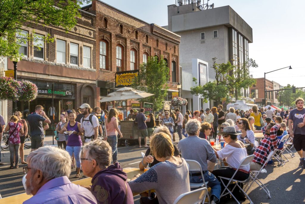 save money; Bozeman Montana Festival. Festivals in small rural community. Main Street with crowds of people checking out vendors offering all kinds of epicurean delights from cupcakes to sausage..Festival in downtown Bozeman Montana . Bite of Bozeman , kick off to annual Sweet Pea Festival. Summertime fun.