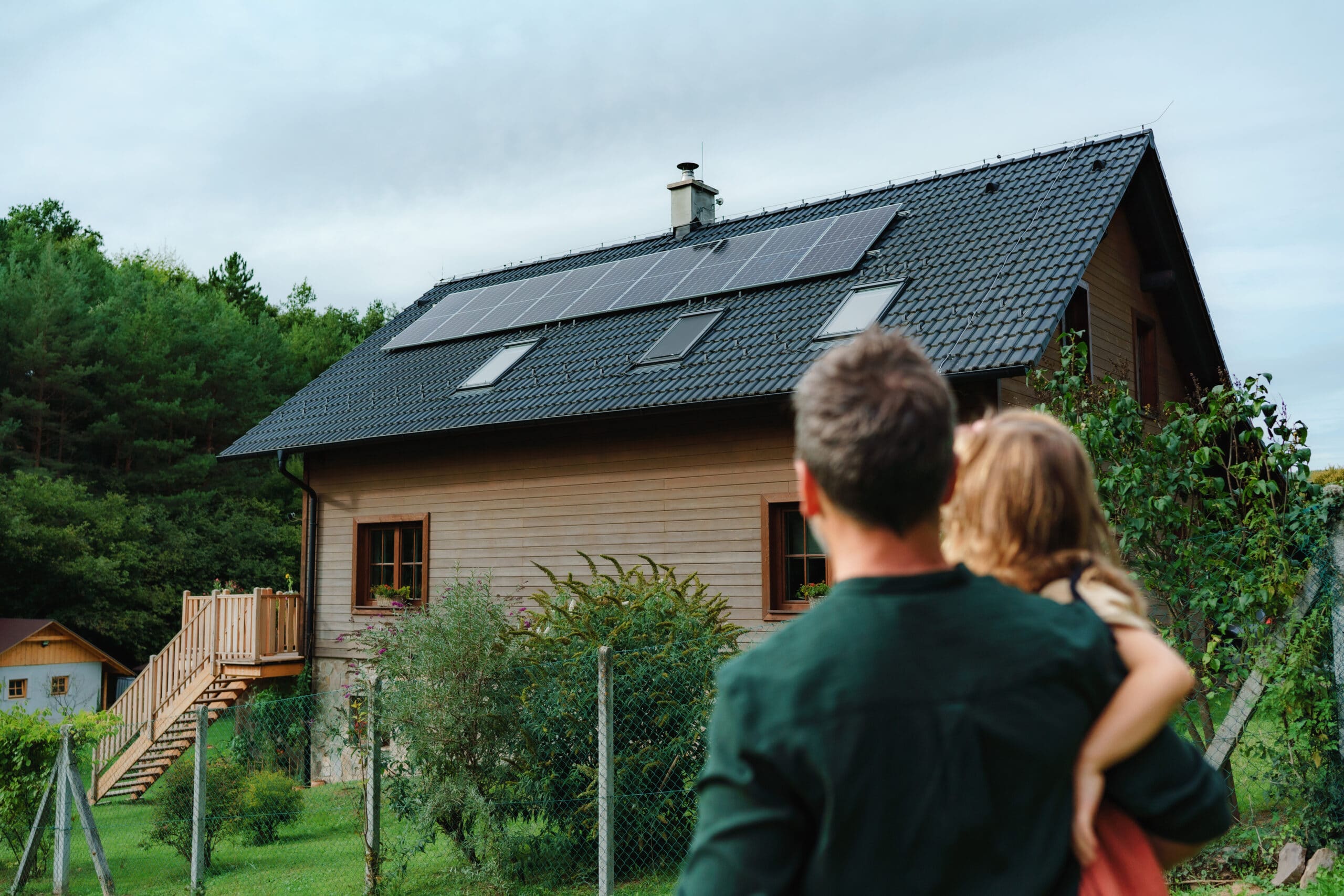 surprising tax write-offs. family looking at house with solar panels.