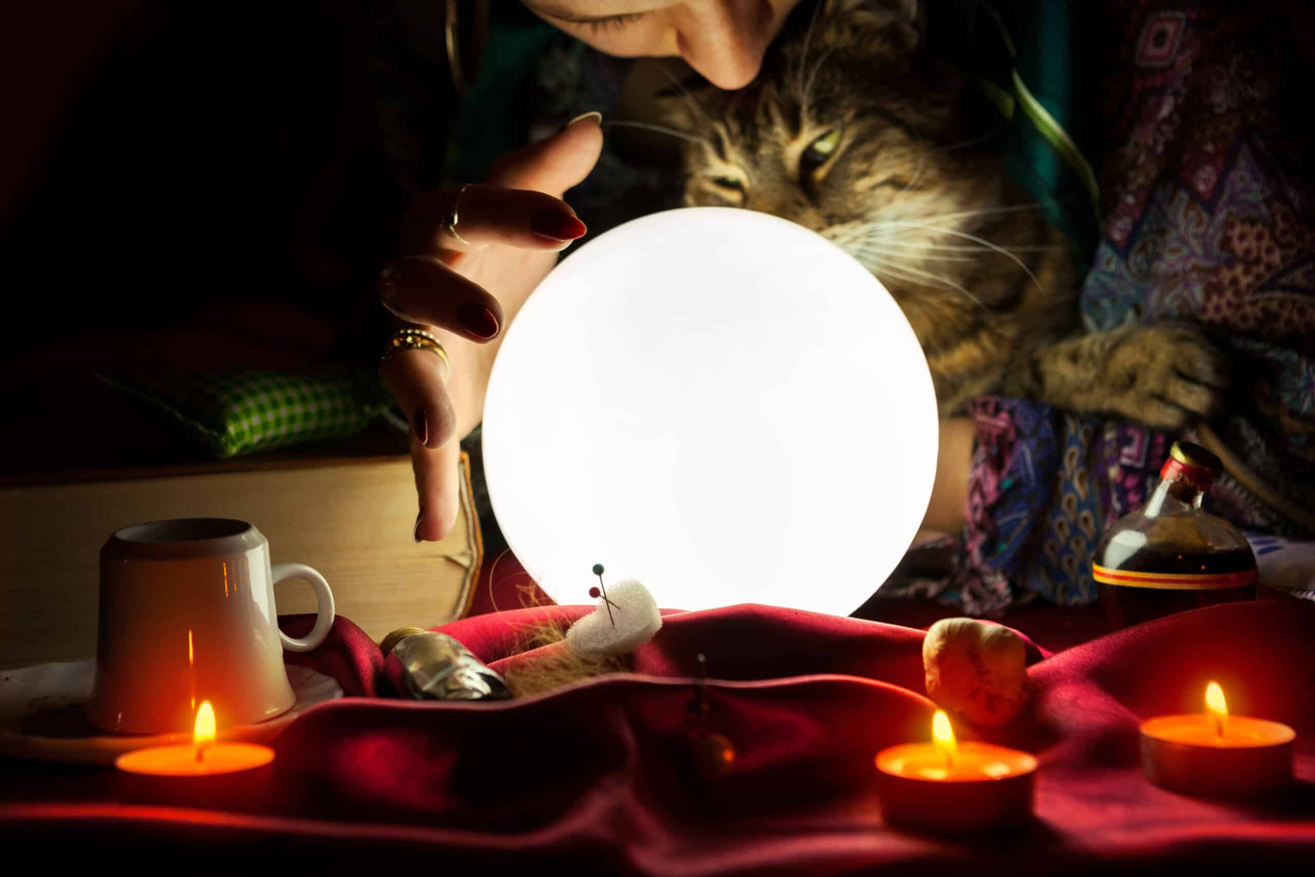 side hustles. Glowing crystal ball with gypsy fortune teller who holds a cat in the background