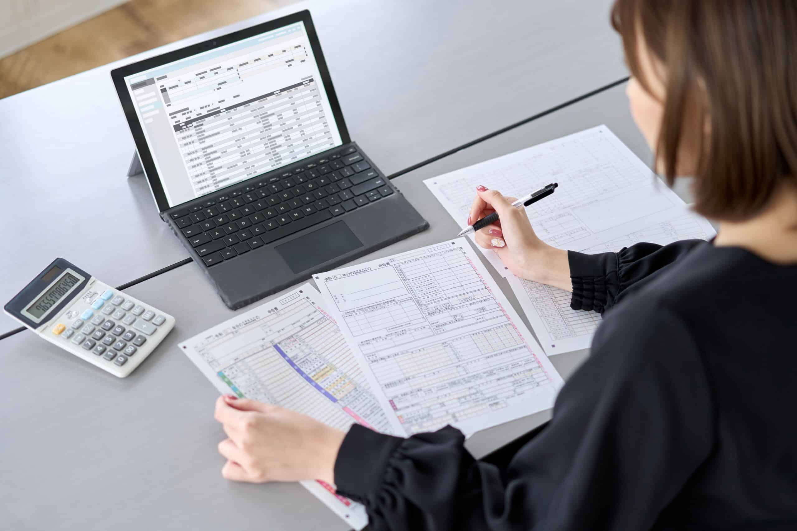 Expense-tracking. Asian woman preparing tax return documents